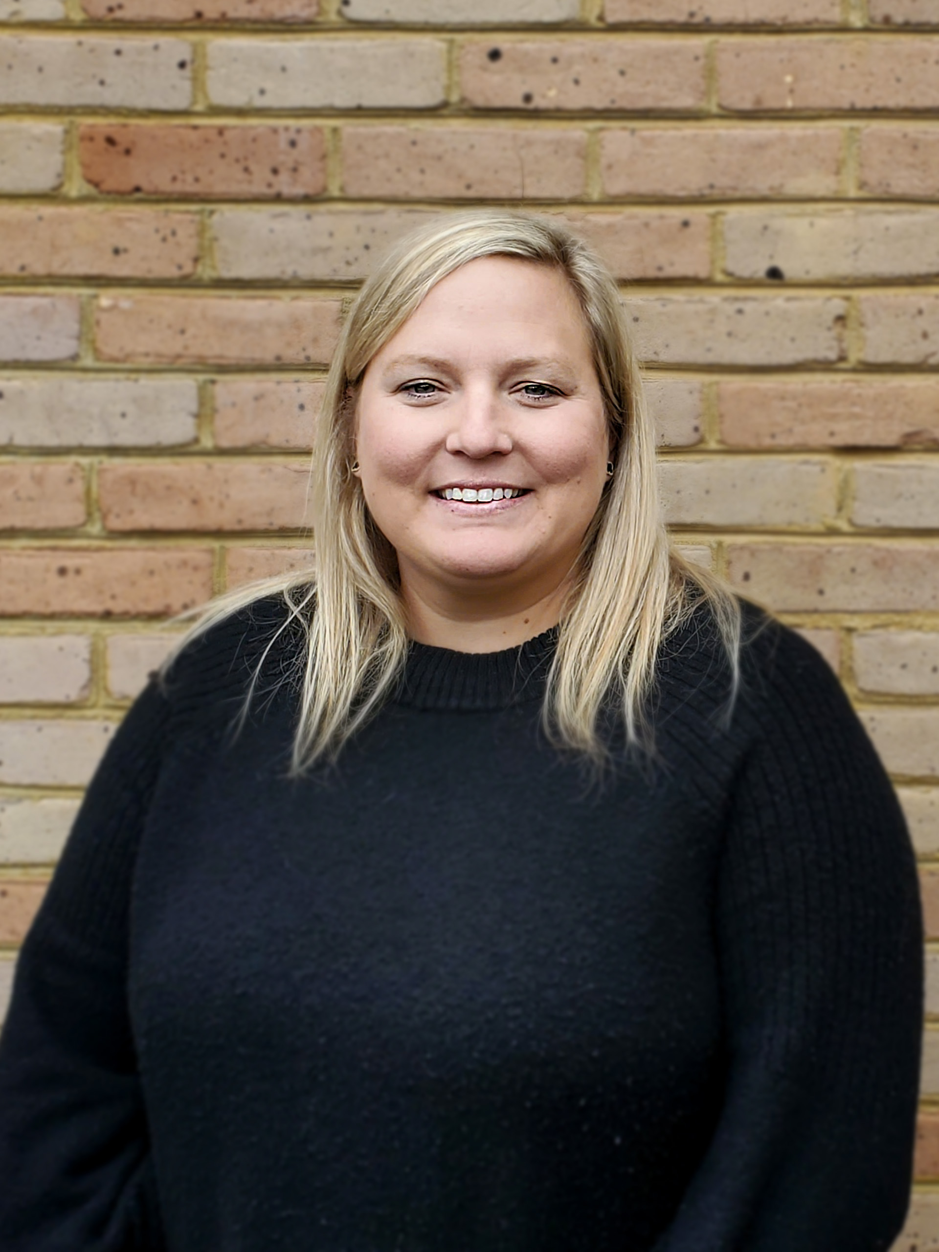 Blonde woman smiling at camera