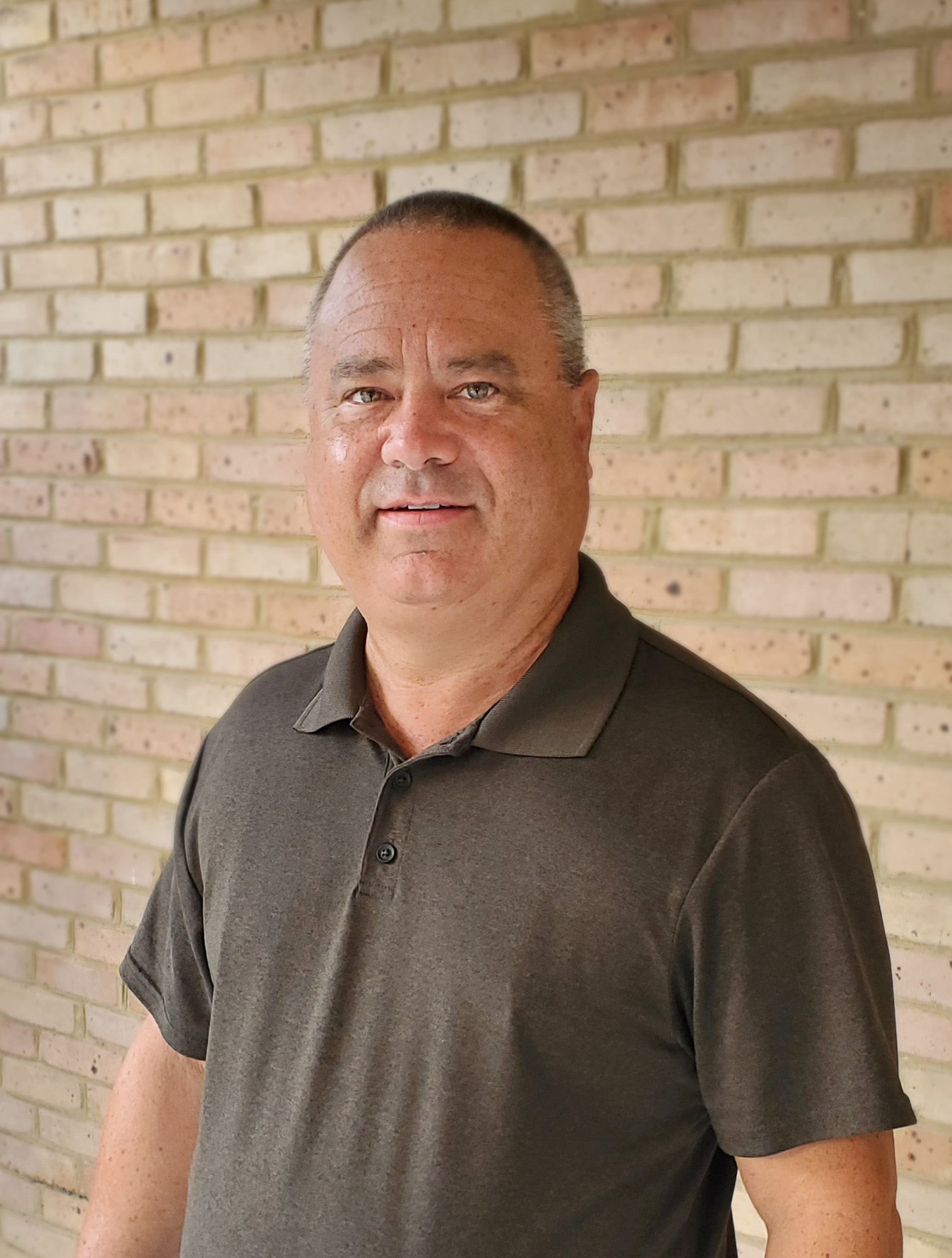 Portrait of man in brown polo shirt