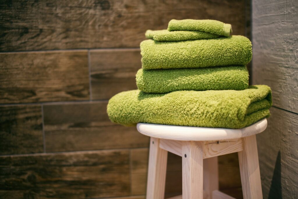 photo of folded green towels