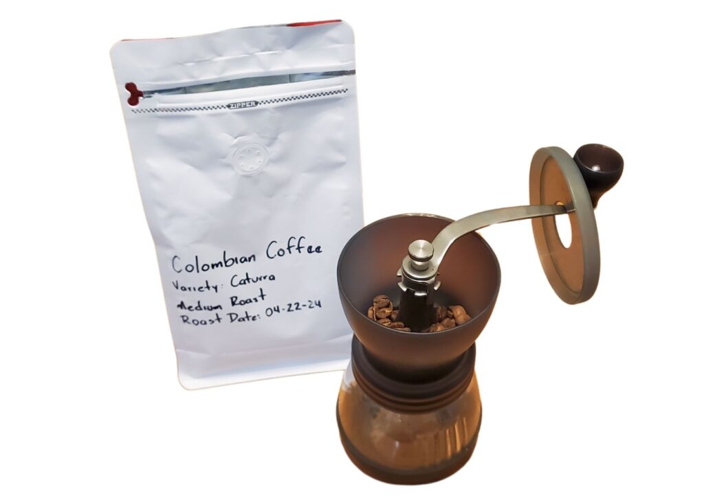 Photo of hand-labeled coffee bag with beans in a coffee grinder