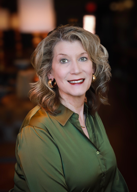 portrait of a woman with blond hair and glasses