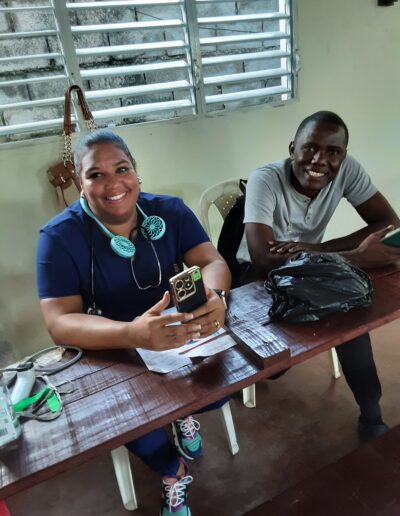 Smiling man and woman sitting at small table in concrete room