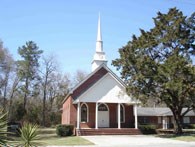 red brick building with white columns and a big white steeple